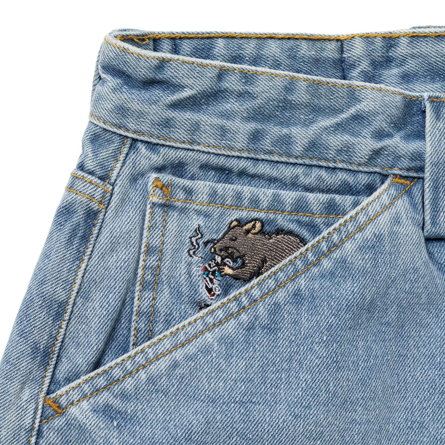 Close-up of a denim pocket with a bear embroidered design on a white background