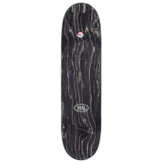 A skateboard deck with a dark, weathered black wood grain finish, featuring a circular 'REAL' brand logo near the center and a small red and white logo near the nose.
