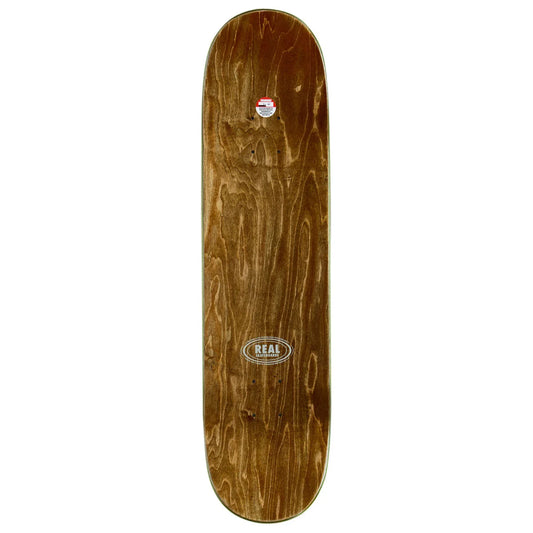 A wooden skateboard deck with a natural brown wood grain finish, featuring a 'REAL' brand logo sticker near the center and a smaller sticker near the nose, shown against a plain white background.