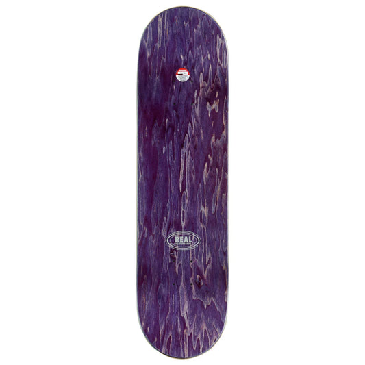 A skateboard deck with a dark purple woodgrain finish, featuring a circular Real brand logo near the bottom center and a small sticker near the top, shown against a plain white background.