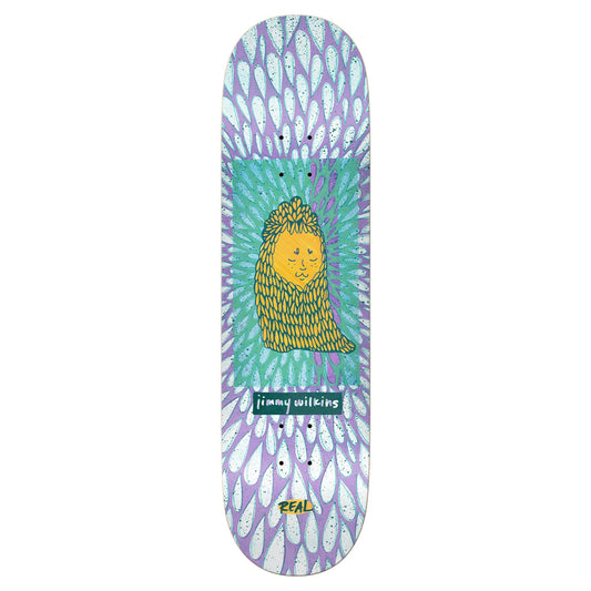 Skateboard deck with a colorful design featuring a face and the brand 'Real' on a white background.