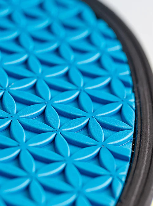 Close-up of a blue textured circular object with a geometric pattern