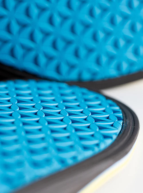 Close-up of blue textured coasters with a geometric pattern.