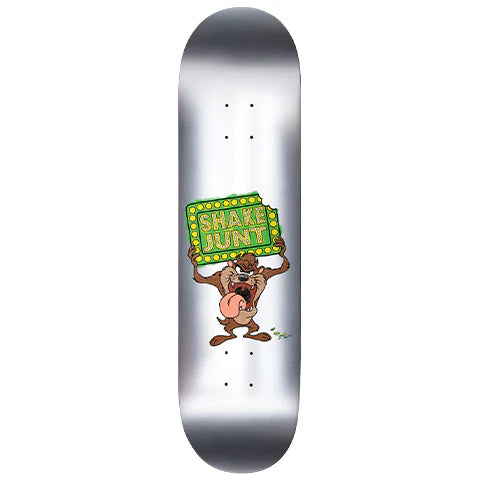 Skateboard deck with cartoon character and 'Shake Junt' logo on a white background