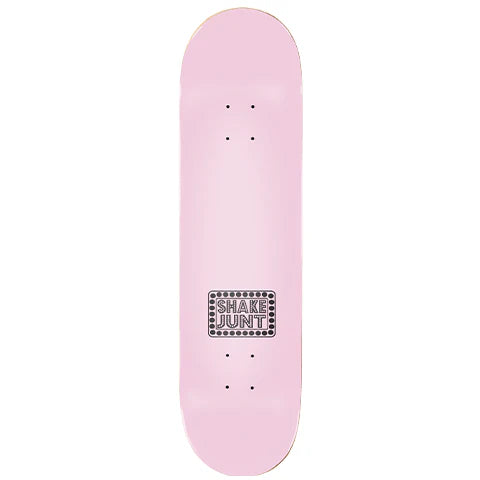 A light pink skateboard deck shown vertically against a plain white background, featuring a black and white 'SHAKE JUNT' logo sticker near the center.