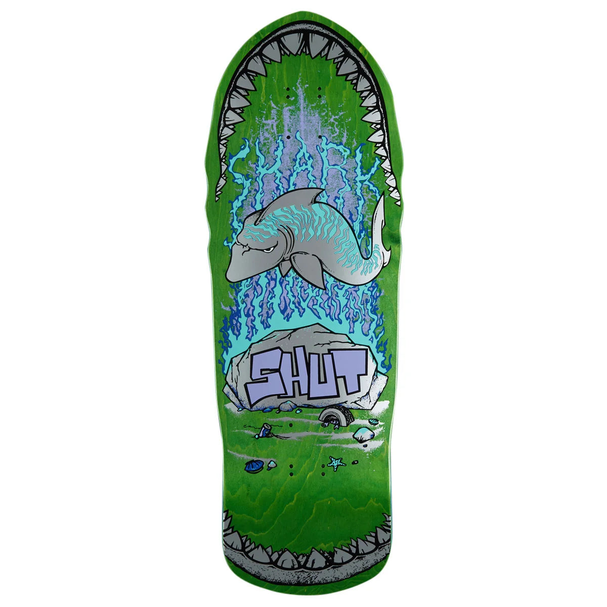 A skateboard deck featuring a green background with a shark graphic inside an open mouth, blue lightning effects, a gray rock with the word 'SHUT' on it, and small fish details near the bottom.