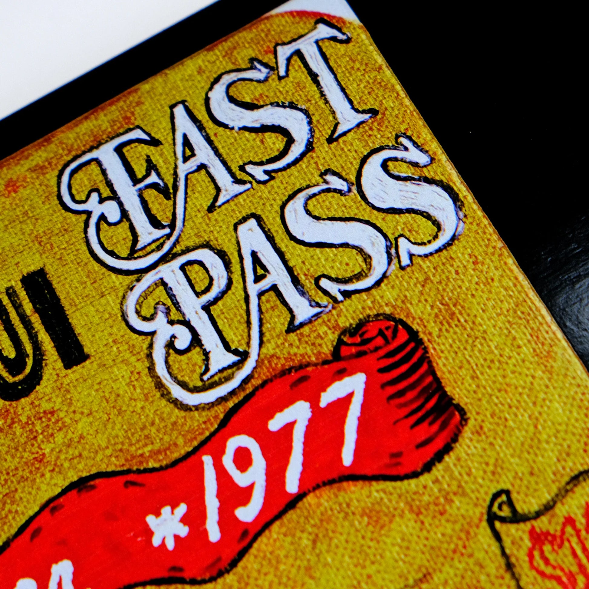 Vintage-style 'Fast Pass' ticket with red ribbon and '1977' text on a yellow background.