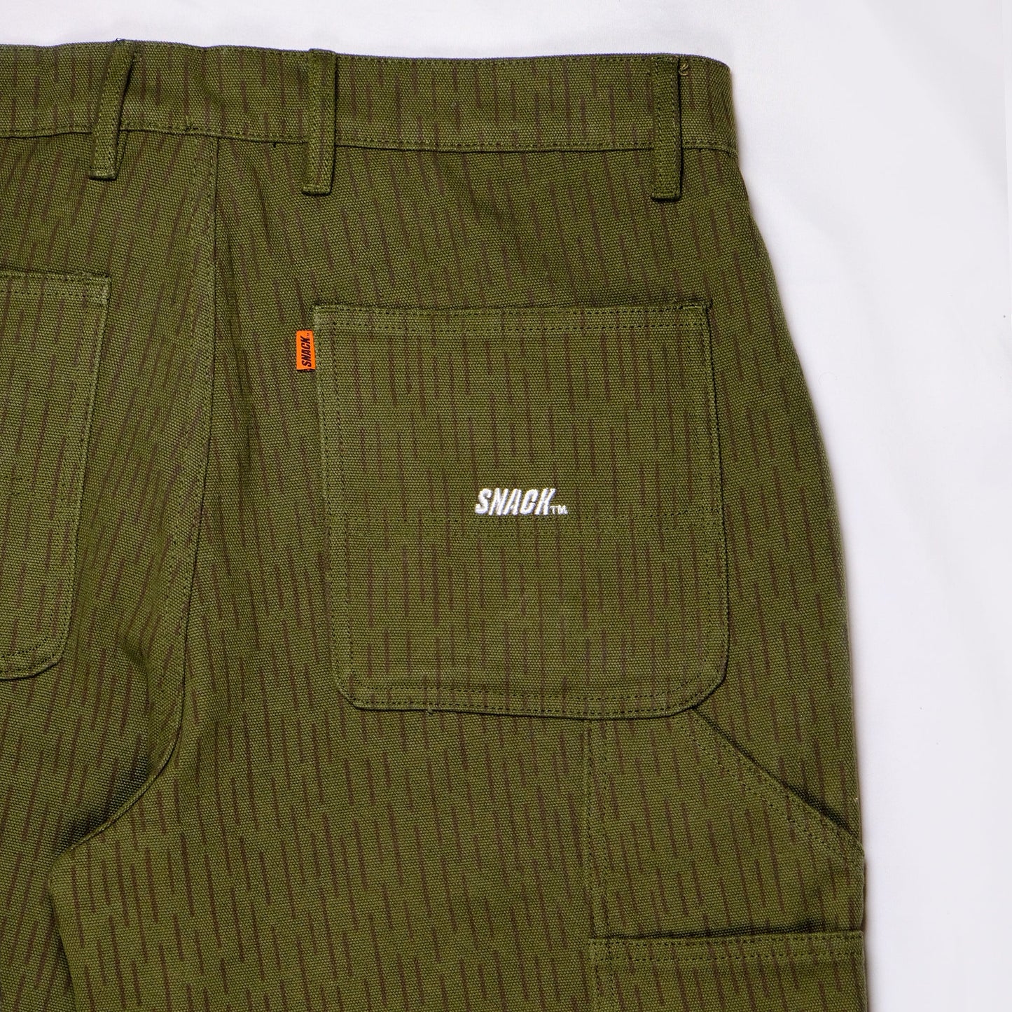 Green corduroy pants with a visible brand logo on a white background