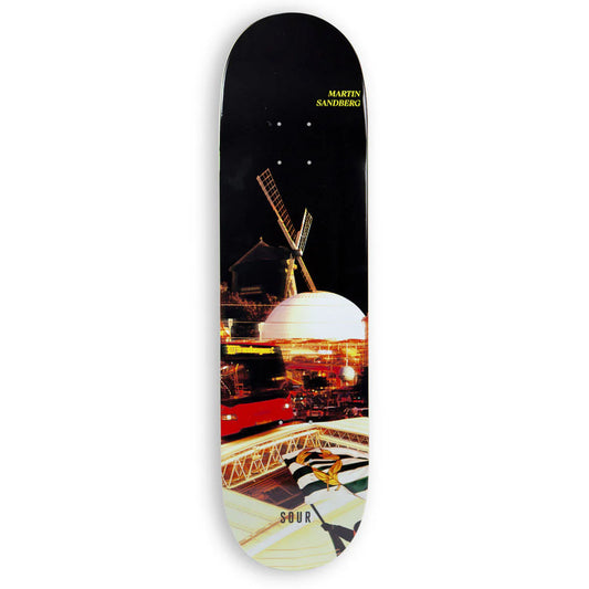 Skateboard deck with a scenic design of a windmill and dome building at night.