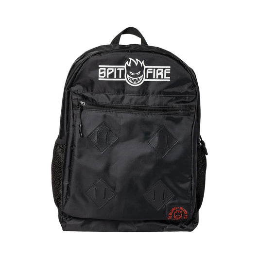 A black backpack featuring the white 'SPIT FIRE' logo on the front pocket, four black diamond-shaped patch details, and a small red circular logo near the bottom right corner, set against a plain white background.