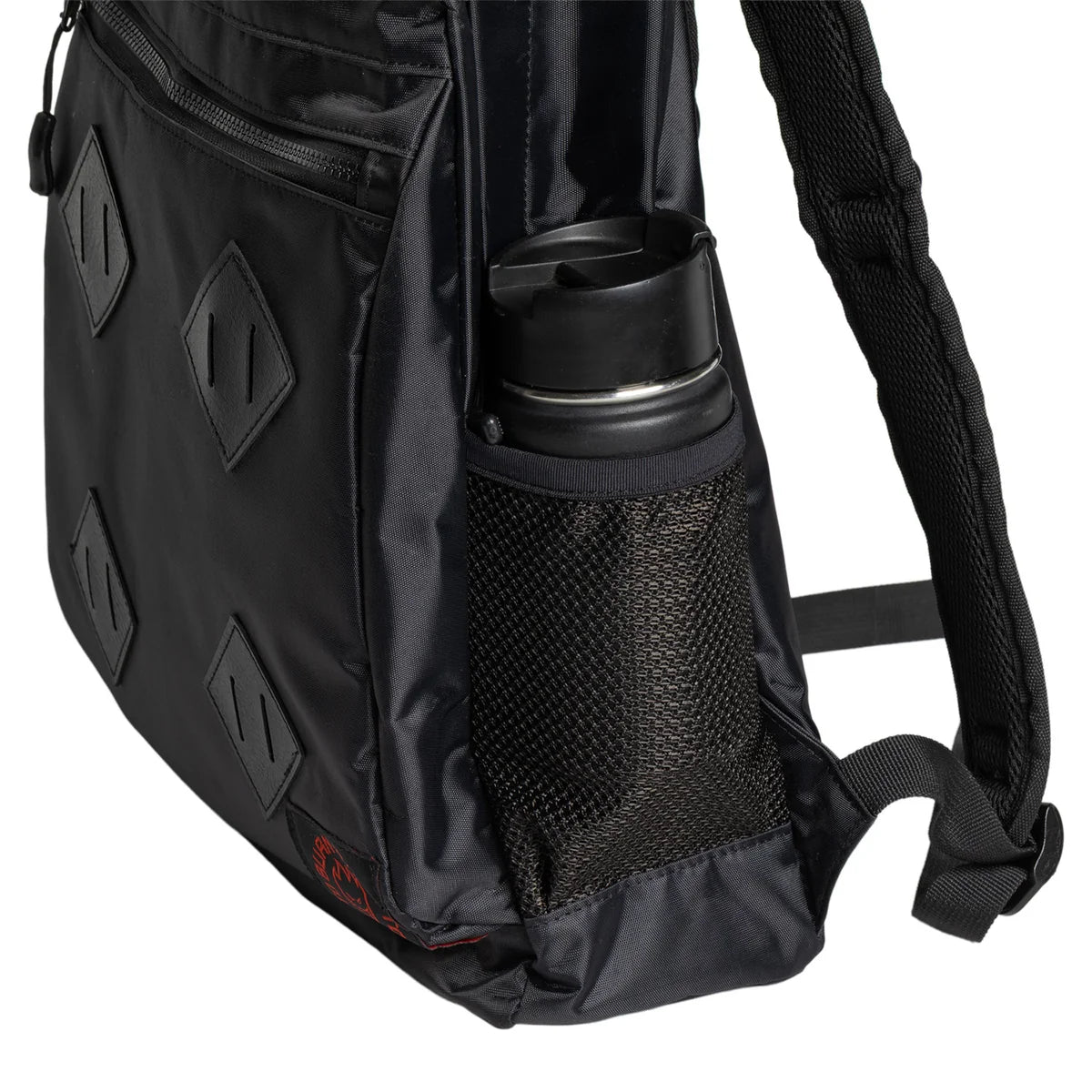 Close-up of a black nylon shoulder bag with diamond-shaped embossed patches, a black mesh side water bottle pocket holding a black bottle, and a black shoulder strap on a white background.