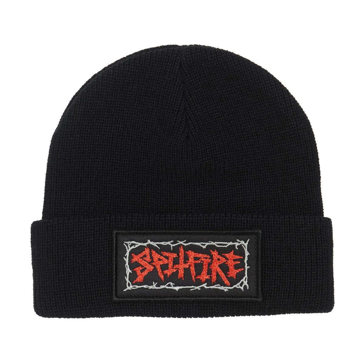 A black knit beanie hat featuring a rectangular embroidered patch on the folded cuff. The patch displays the word 'spitfire' in a red, jagged, metal-style font with white barbed wire borders.