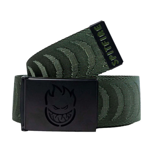 An olive green web belt with a black metal buckle featuring a flame logo, with the buckle turned to show the brand name 'SpITFIRE' on the tongue.
