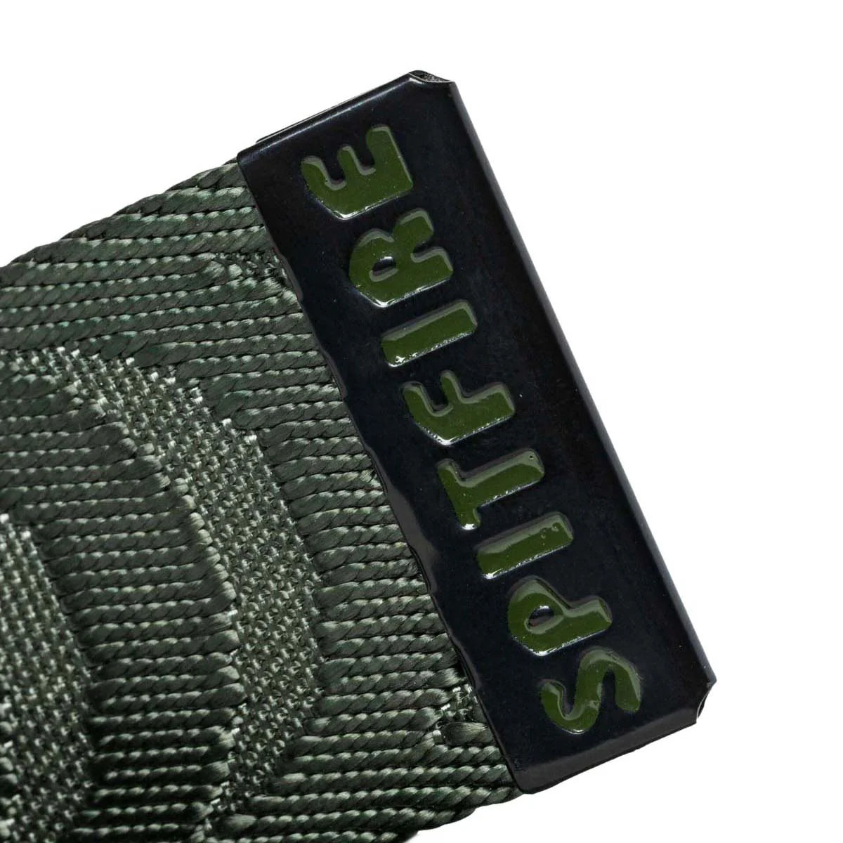 Close-up of a tactical belt buckle with the brand name 'SPITFIRE' in olive green raised lettering on a glossy black metal plate, attached to an olive drab woven webbing strap, set against a plain white background.