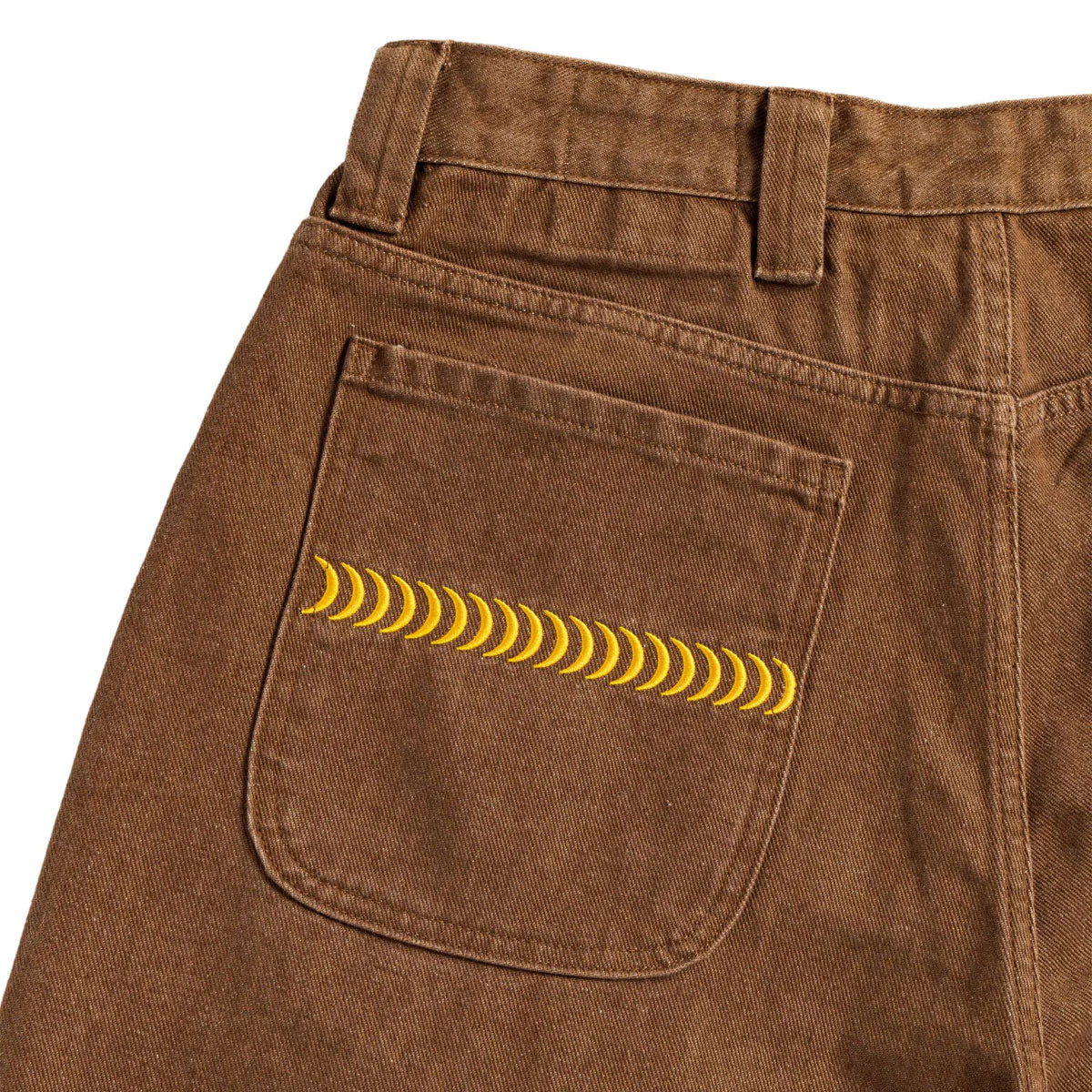 Brown pants with a yellow pattern on the back pocket against a white background