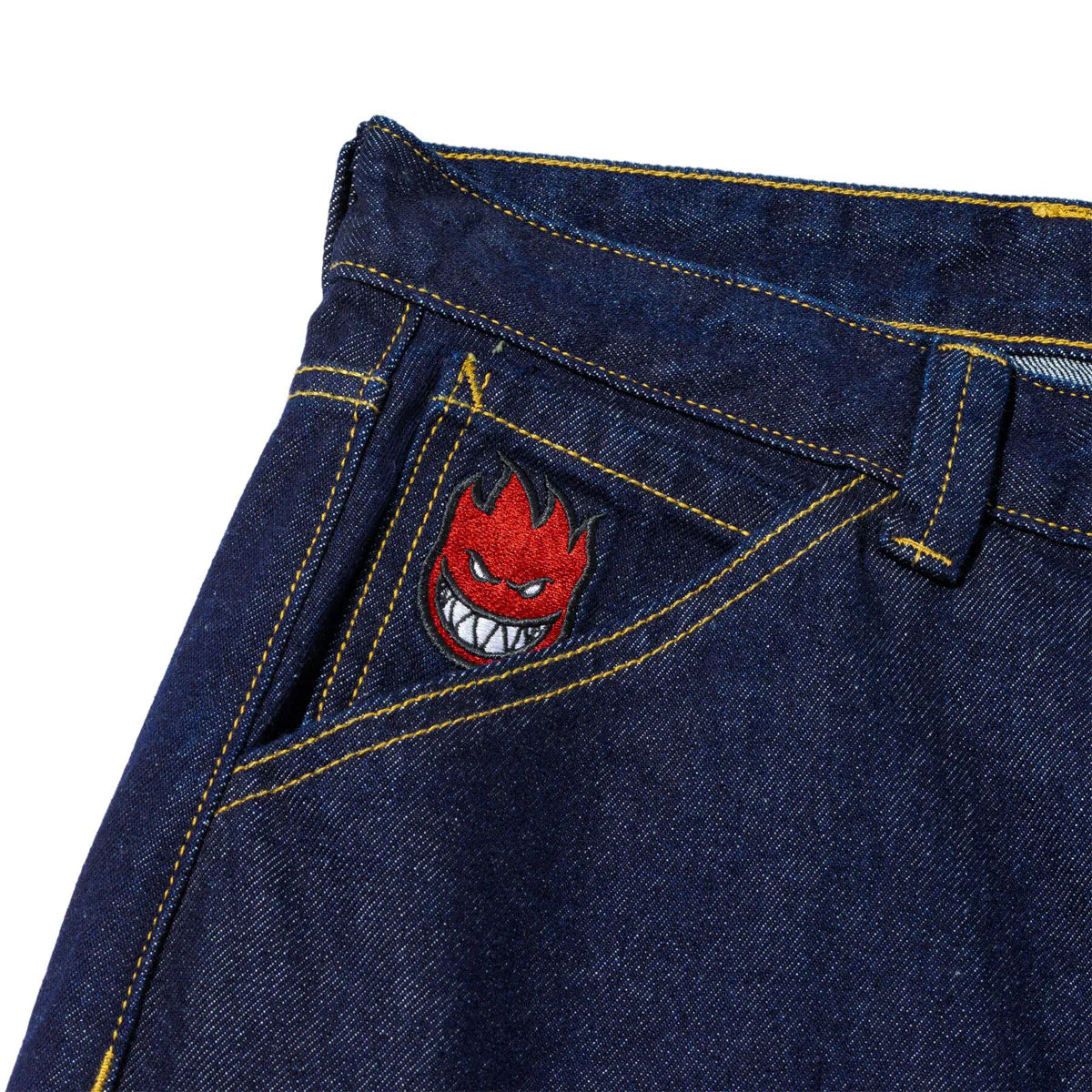 Close-up of blue denim fabric with a red and black embroidered design on a white background