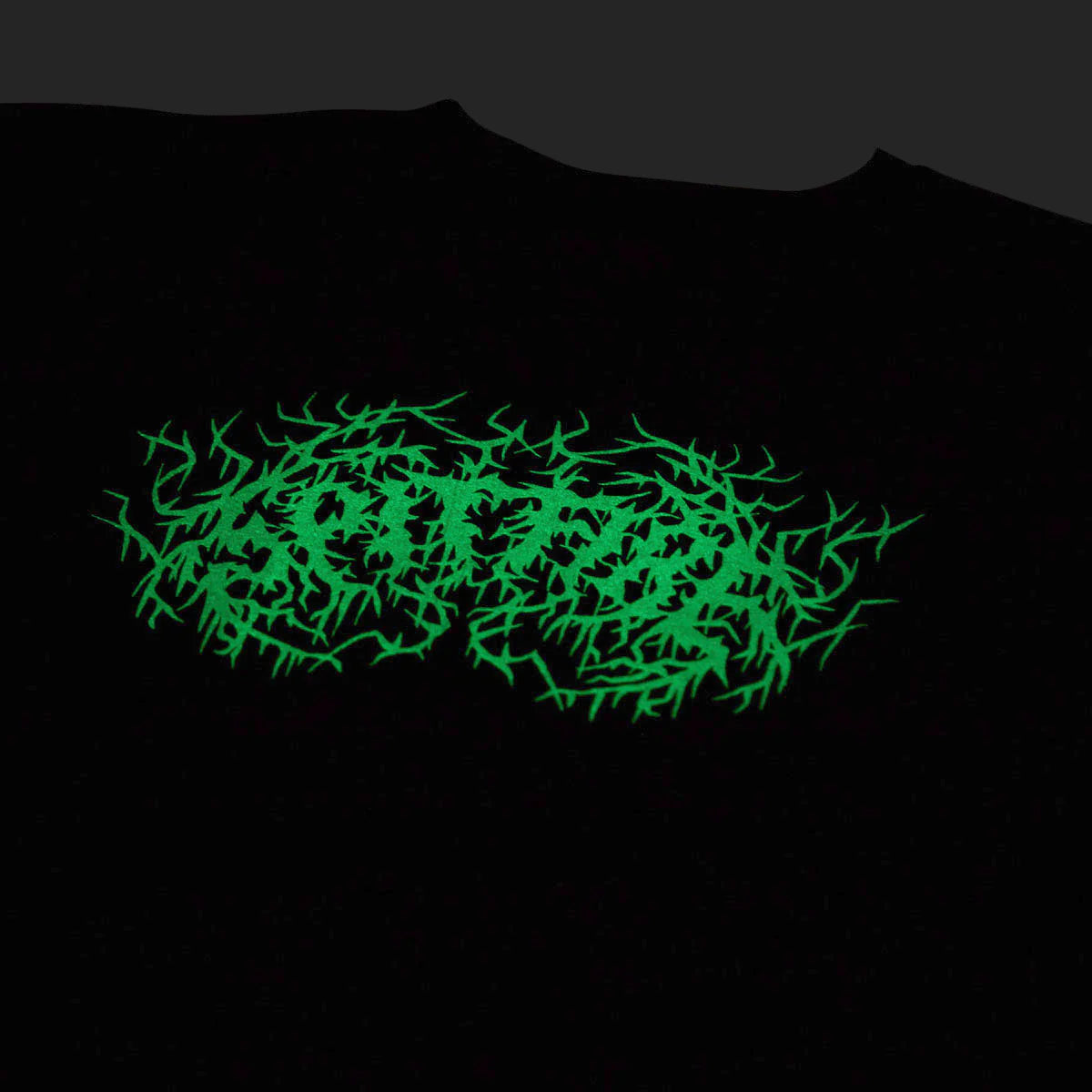 A black crewneck t-shirt featuring a glowing neon green thorny graphic logo across the chest, shown against a dark background.