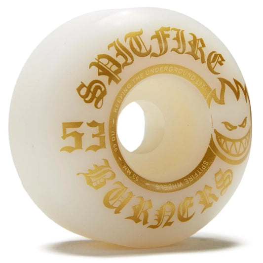 An off-white/cream skate wheel with gold gothic lettering that reads 'SPITFIRE ZBURERS' and '53', plus a gold grinning face graphic, on a white background.