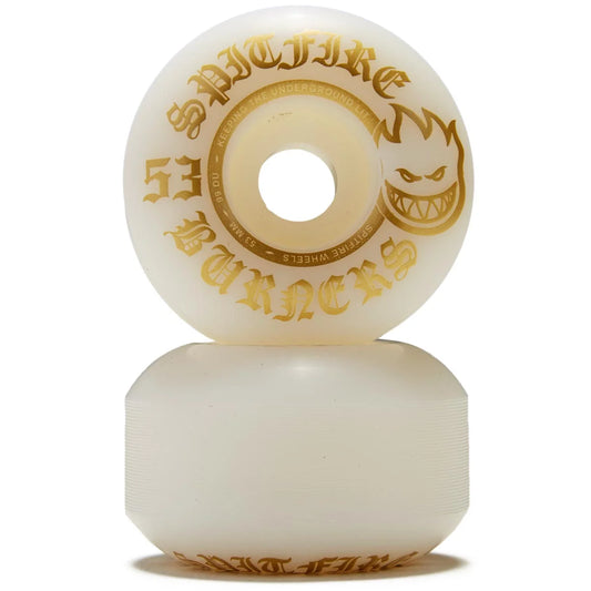 Two white skateboard wheels with gold text on a white background