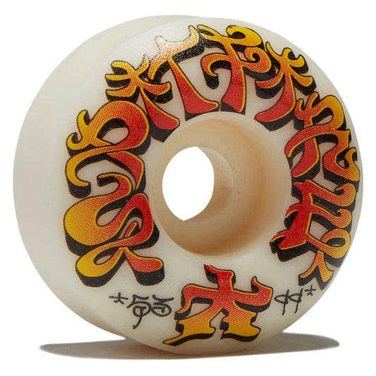 An off-white skateboard wheel featuring stylized Japanese katakana characters printed in a red, orange, and yellow gradient with black outlines.