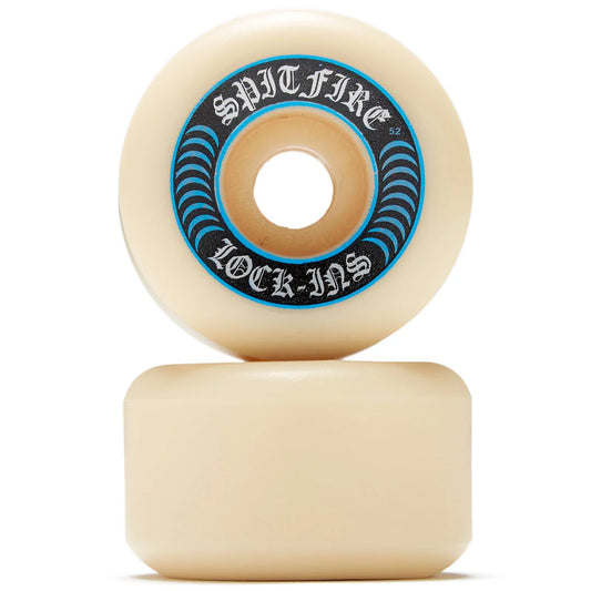 Two cream-colored skateboard wheels stacked vertically on a white background, with the top wheel showing a blue and black 'Spitfire Lock-In' sticker.