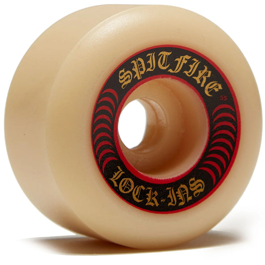 A single skateboard wheel in a translucent cream color, featuring a black and red inner ring with gold lettering that reads 'SPITFIRE' and 'LOCK-INS'.