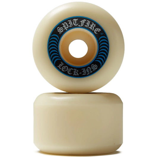 Two cream-colored skateboard wheels stacked vertically on a white background, with the top wheel showing a blue and black 'Spitfire Lock-In' sticker.