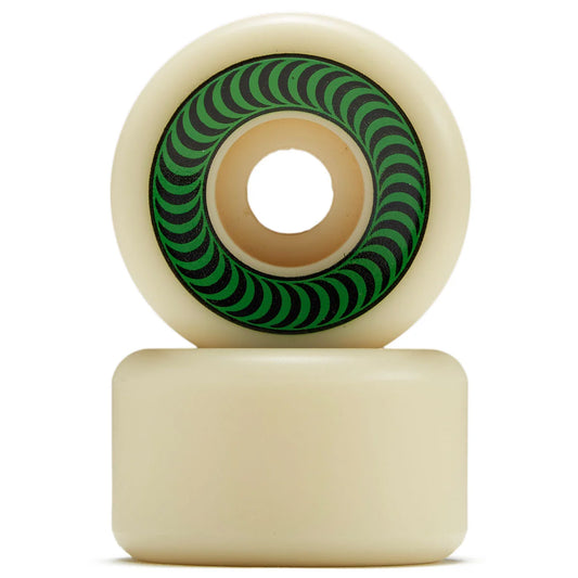 Two cream-colored skateboard wheels stacked vertically, with the top wheel showing a green and black spiral pattern on its inner ring.