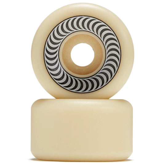 Two cream-colored skateboard wheels stacked vertically on a white background, showing the inner barrel with a black and white wavy pattern.