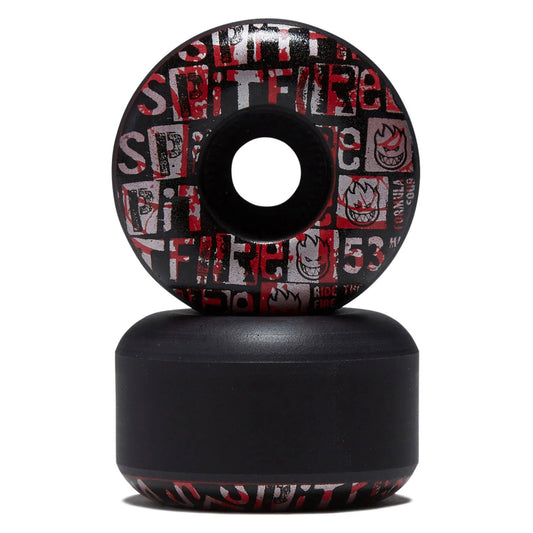 A pair of skateboard wheels stacked vertically on a white background. The top wheel shows a black, red, and white graphic pattern with the text 'SPITFIRE' and flame logos, while the bottom wheel is a solid matte black.