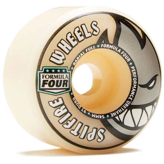 A single Spitfire Formula Four skateboard wheel with a translucent cream-colored urethane body, featuring a black and gray graphic of a snarling wolf on the side and a teal and black 'Formula Four' logo on the front.