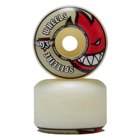 A single skateboard wheel shown upright with its underside resting on a matching wheel base against a plain white background. The wheel face is cream with a large red devil face graphic and black text reading 'WHEELS' and 'SPITFIRE 93'.