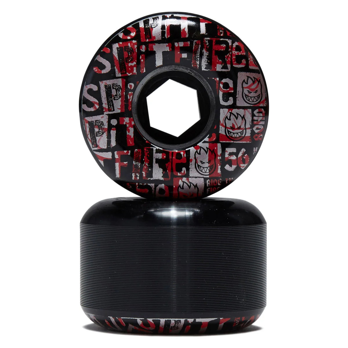 A pair of skateboard wheels stacked vertically on a white background. The top wheel is upright, showing a black base with a red and white graphic pattern of the word 'SPIRIT' and flames.