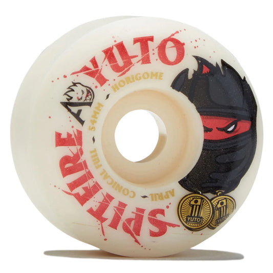 A single white Spitfire Ayuto skateboard wheel with red and black graphics, including a ninja face and gold text, shown on a white background with a soft shadow.