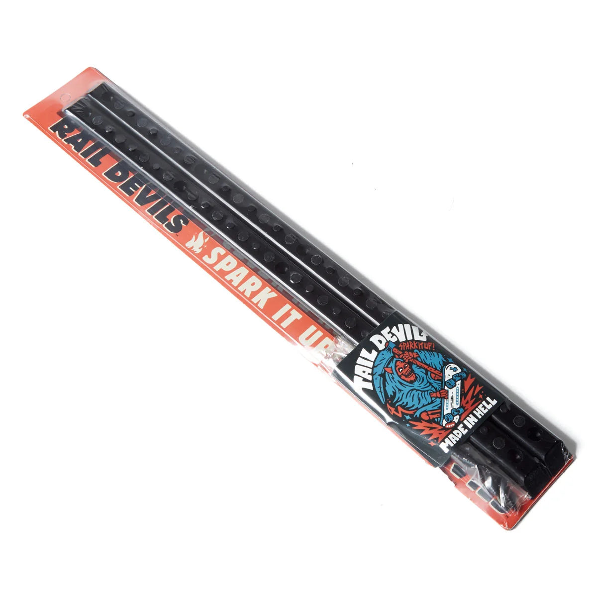 Packaged black spark plugs for Rail Devils motorcycles, sealed in clear plastic with a red and white label featuring the brand name and a blue graphic.