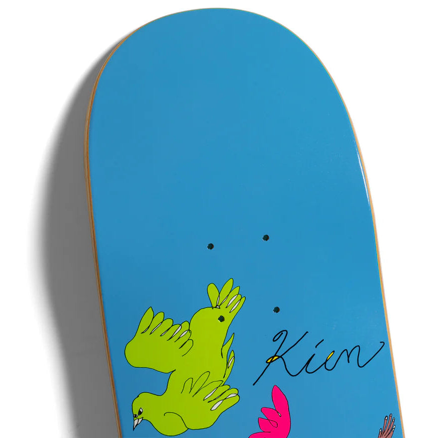 Skateboard deck with a blue background and green and pink birds, featuring the brand 'Kion'.