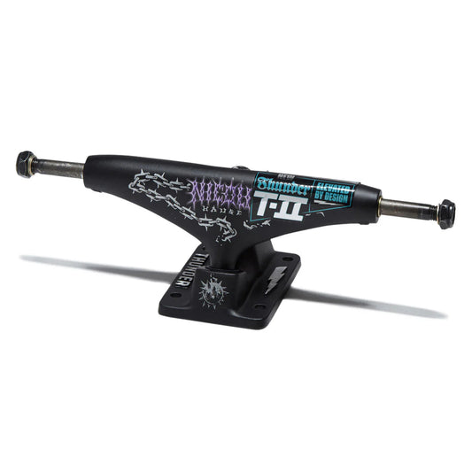 A black skateboard truck with graphic decals, including 'AWOL' and 'Skateboard Building 101', mounted on a black base plate against a white background.