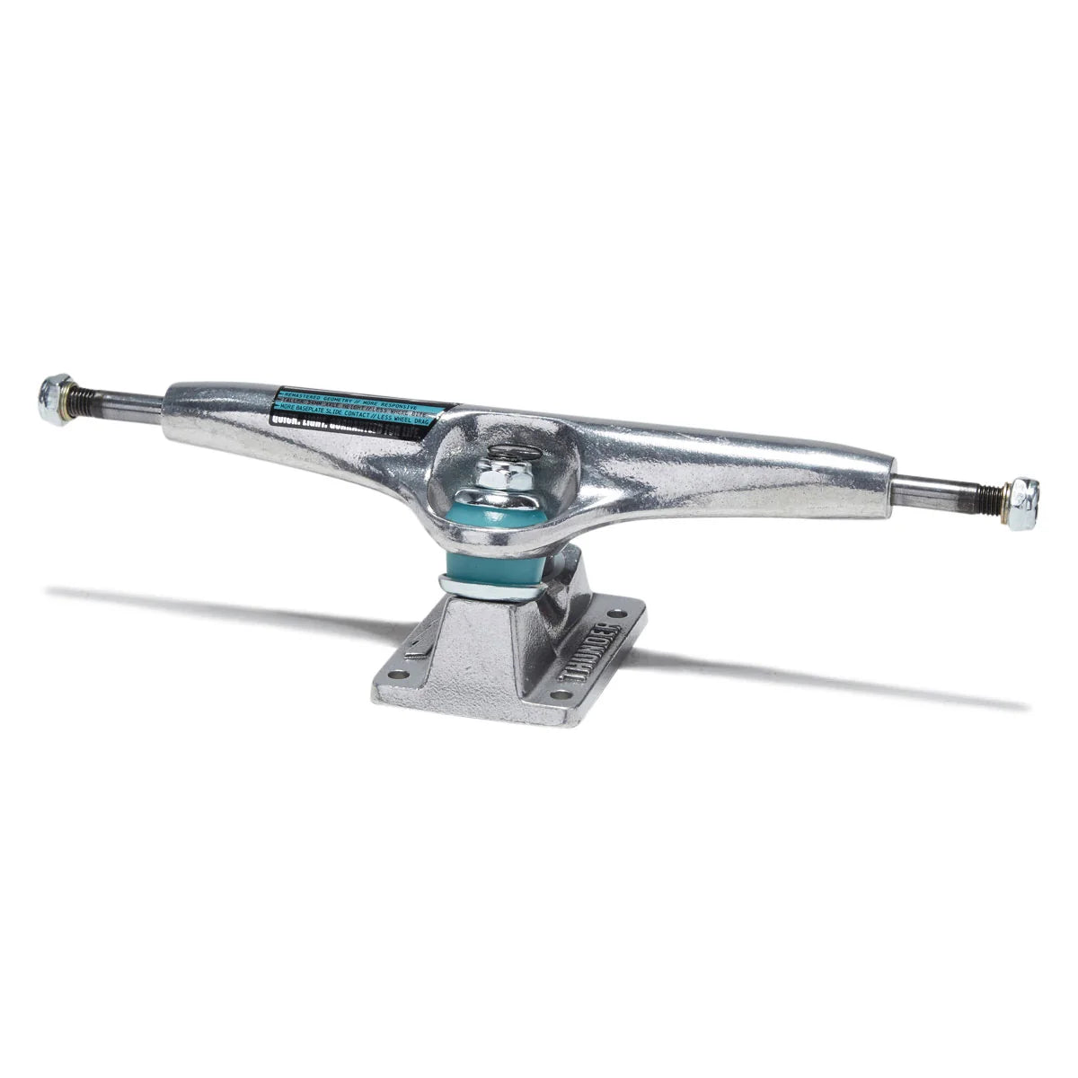 A single skateboard truck with a silver chrome metal body, black and teal sticker labels, and silver hardware, shown on a clean white background with a soft shadow.