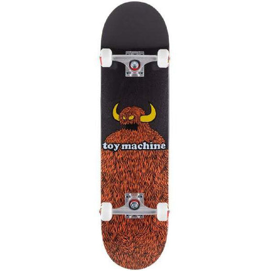 Skateboard with a black and brown design featuring a bear and 'toy machine' text on a white background.