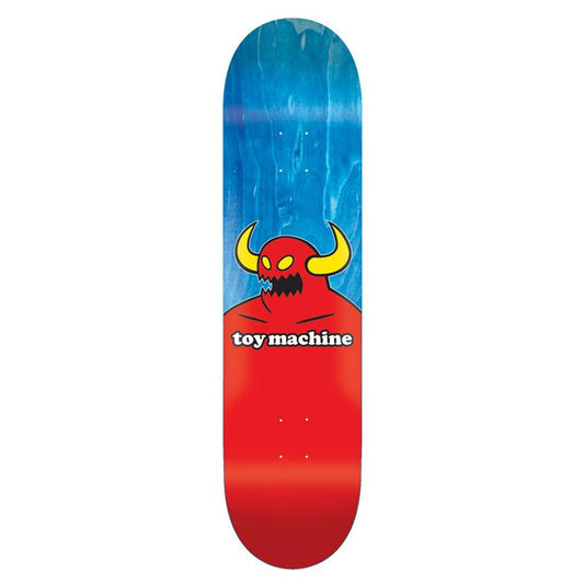 Skateboard deck with a red and blue design featuring a cartoonish monster and 'toy machine' text on a white background.