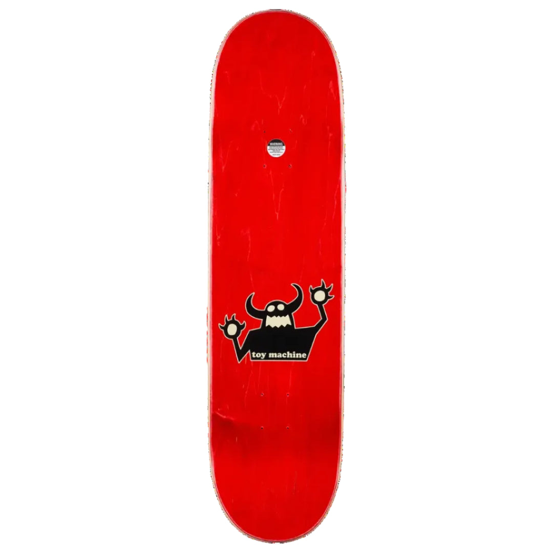 A red skateboard deck shown vertically against a plain white background, featuring a black cartoon devil graphic with white details and the text 'toy machine' near the center.