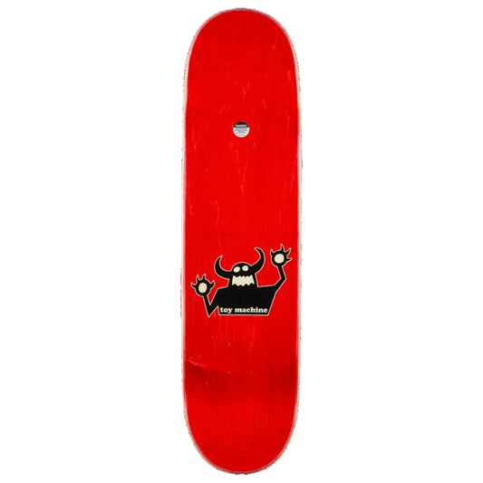 A red skateboard deck shown vertically against a plain white background, featuring a black cartoon devil graphic with white details and the text 'toy machine' near the center.