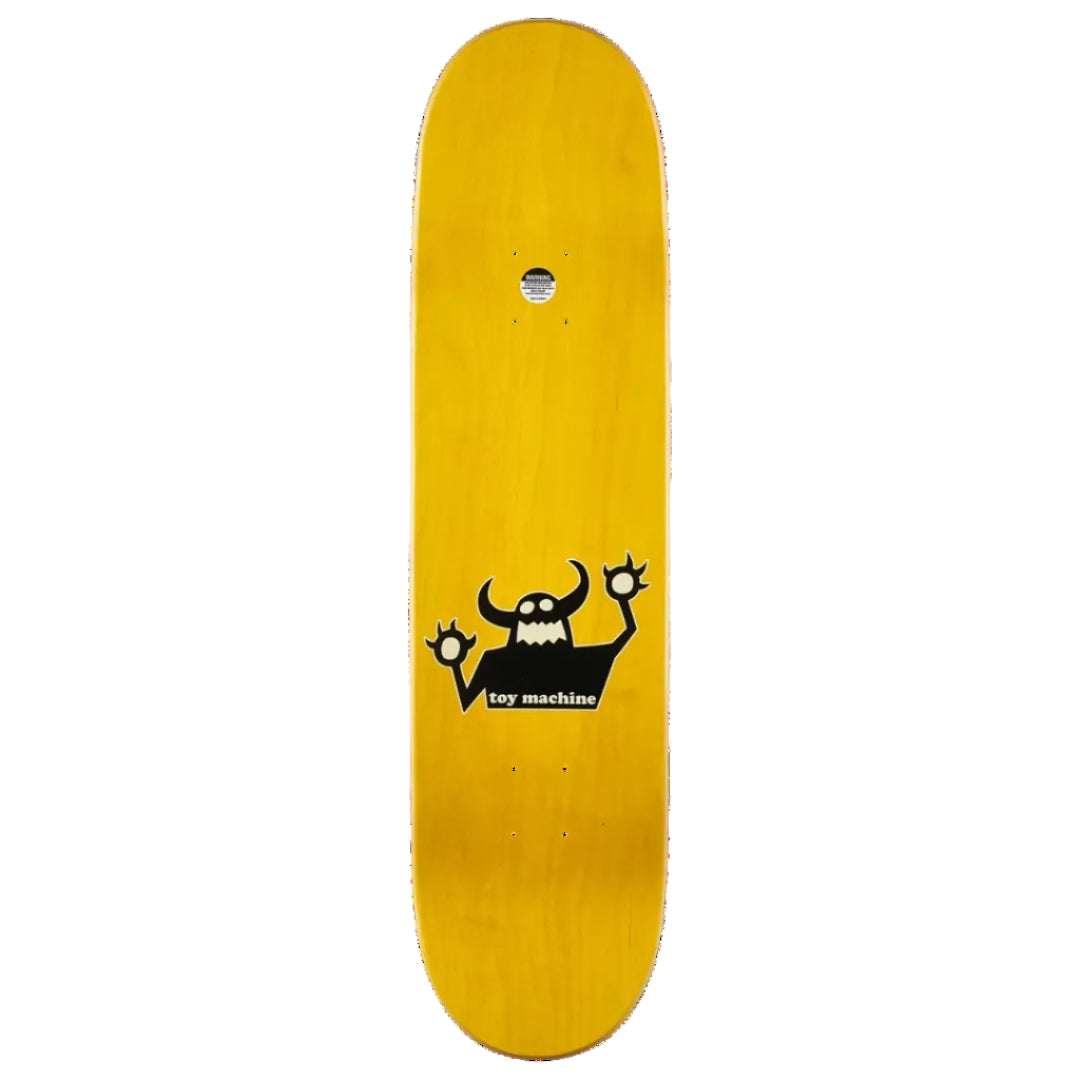 A yellow skateboard deck with a black cartoon monster graphic and the text 'toy machine' printed on the underside, shown against a plain white background.