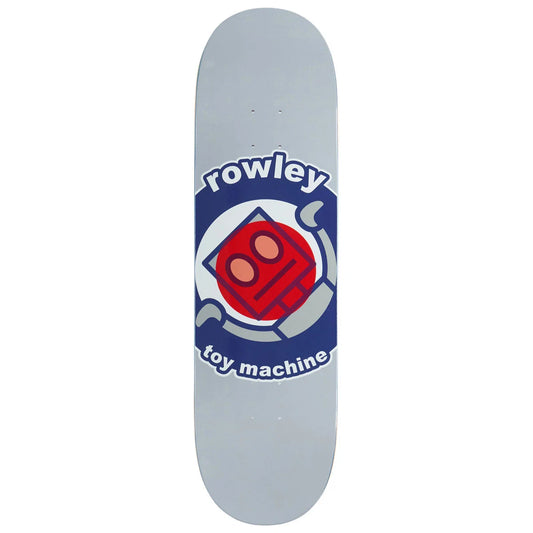 A skateboard deck shown vertically against a plain white background. The deck has a light gray base with a large graphic in the center featuring the text 'rowley' and 'toy machine' in white on a dark blue background, surrounding a red and orange robot face graphic.