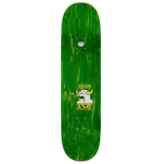 A green skateboard deck with a natural wood-grain pattern and a central graphic of a cartoon goat smoking a joint, with the text 'Miles' and 'Toy Machine' in yellow.