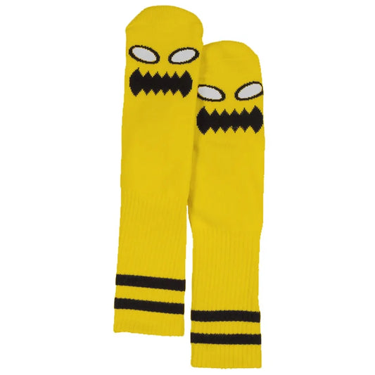 Yellow leg warmers with a black mouth design on a white background