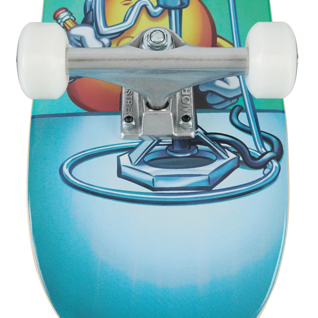 A close-up of a skateboard deck featuring a graphic illustration of a cartoon flame character wearing goggles and holding a welding torch, with a bright blue and teal gradient background. The skateboard is shown from the underside, revealing white wheels and silver trucks.