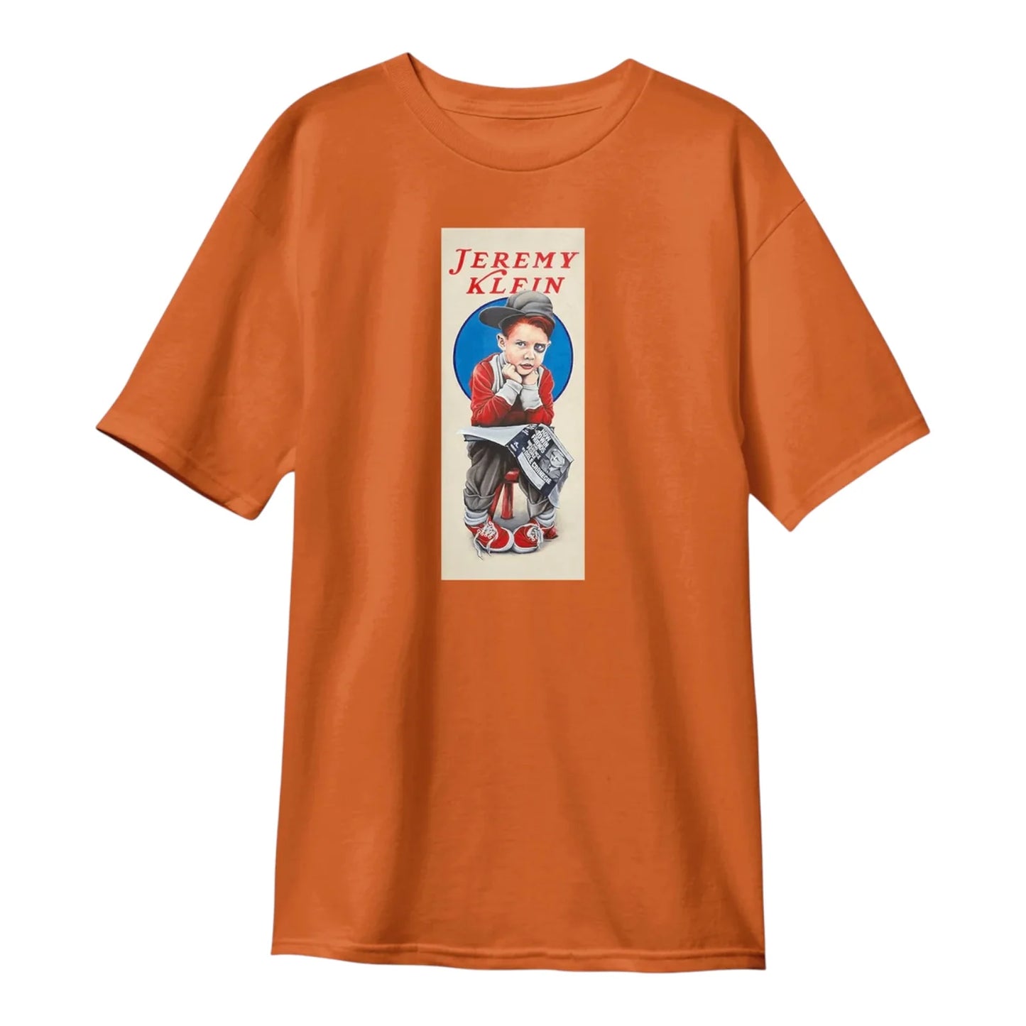 An orange short-sleeve crewneck t-shirt featuring a vintage-style graphic print of a boy wearing a hat, with the text 'JEREMY KLEIN' printed above him.