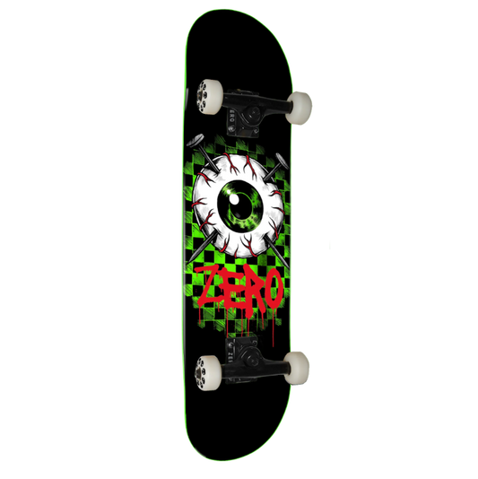 A skateboard shown from the underside, featuring a black deck with a green and black checkered graphic, a large white eyeball design with red details, and the word 'ZERO' in red graffiti-style lettering. The skateboard is equipped with white wheels and black trucks, set against a plain white background.