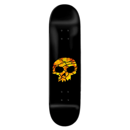 Skateboard deck with a cracked skull design on a black background